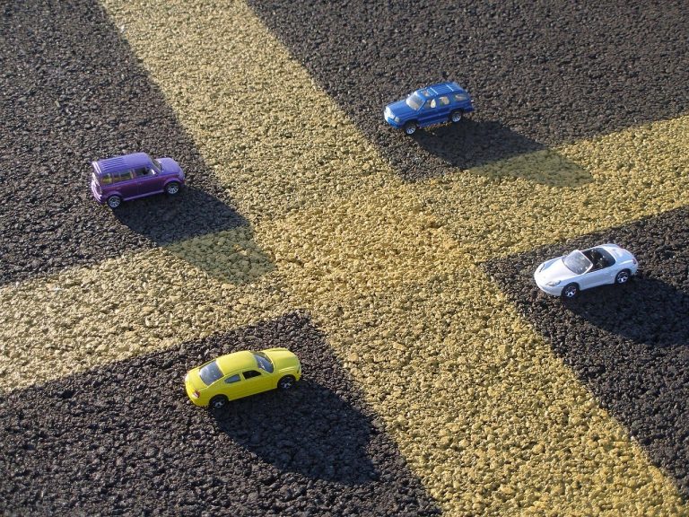 a yellow toy truck on a dirt road