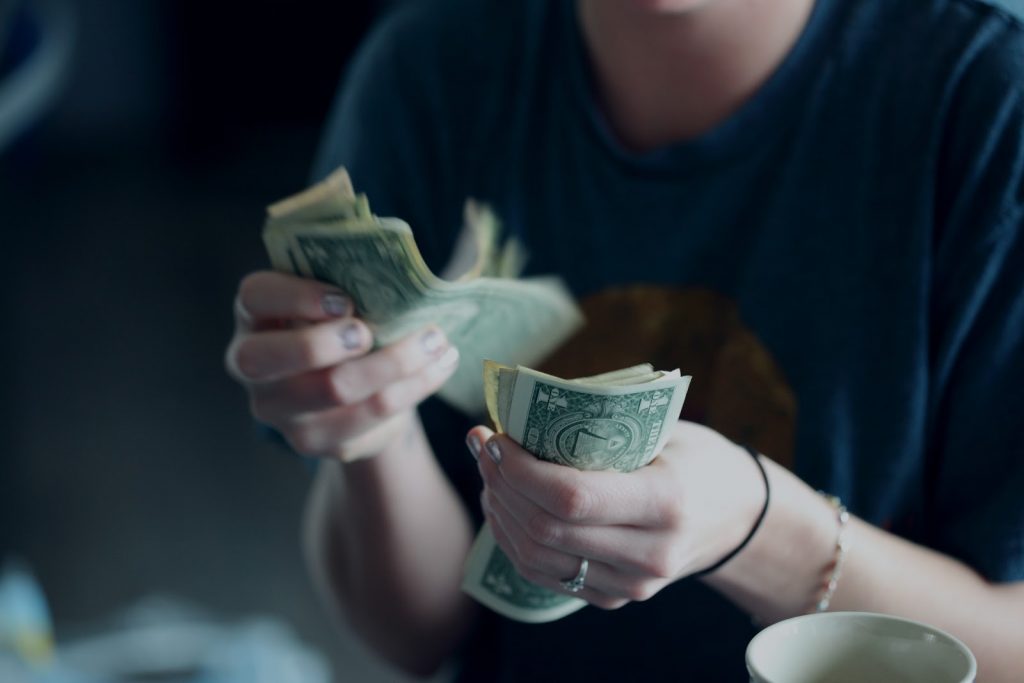 a person holding a green leaf