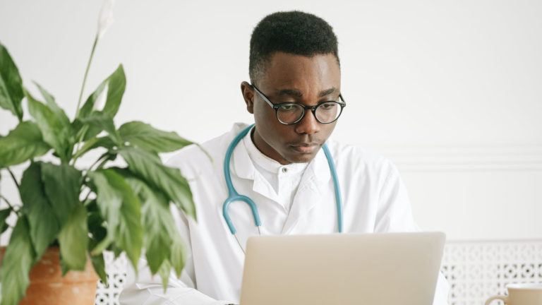 a doctor using a laptop
