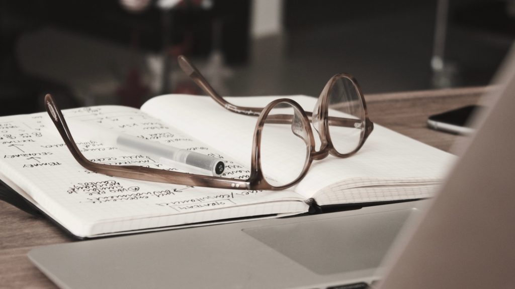 a pair of glasses on a book