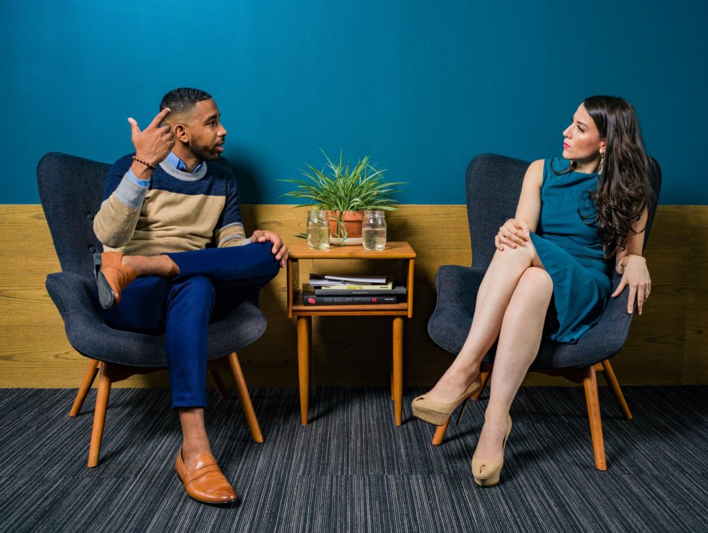 a man and a woman sitting on chairs