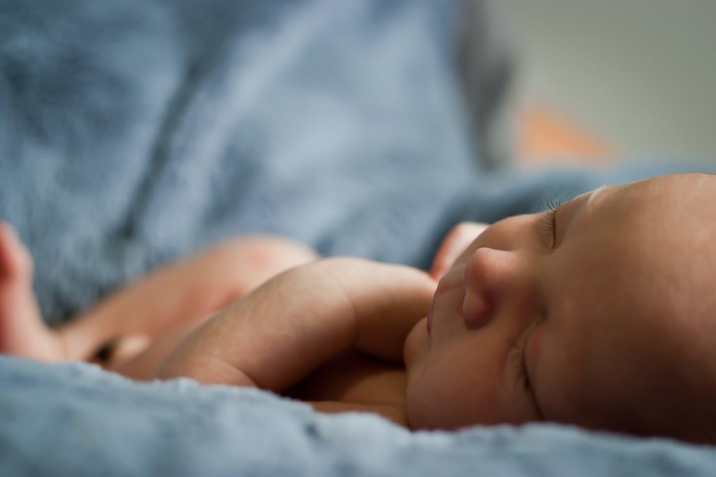 a baby sleeping on a blanket