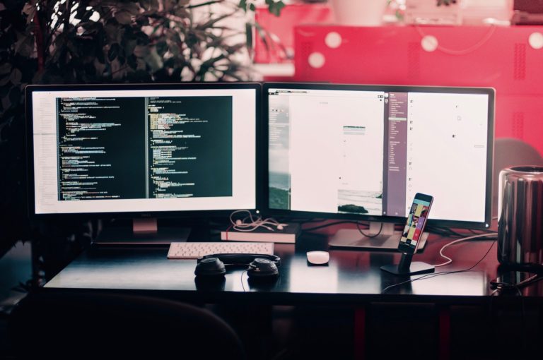 a computer monitor and a keyboard on a desk