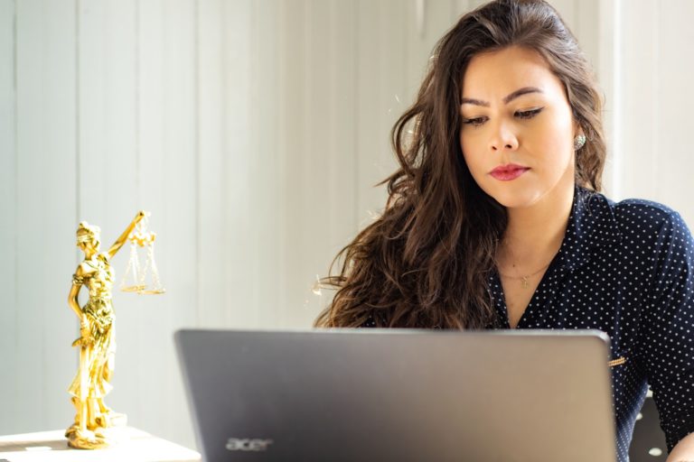 a woman sitting in front of a laptop