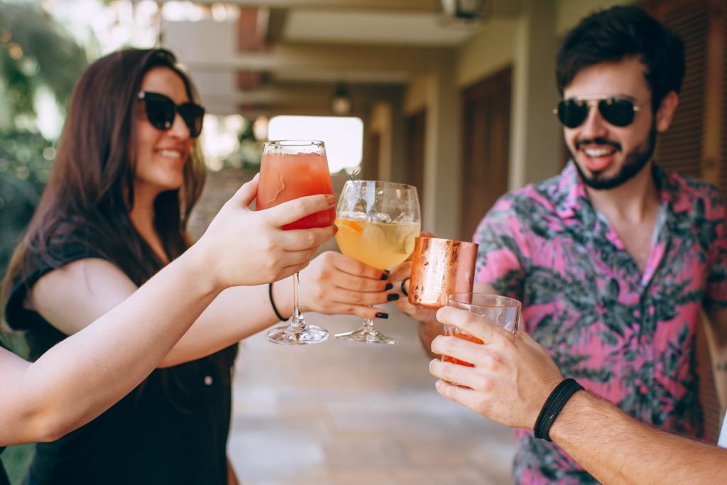 a man and woman holding glasses of beer