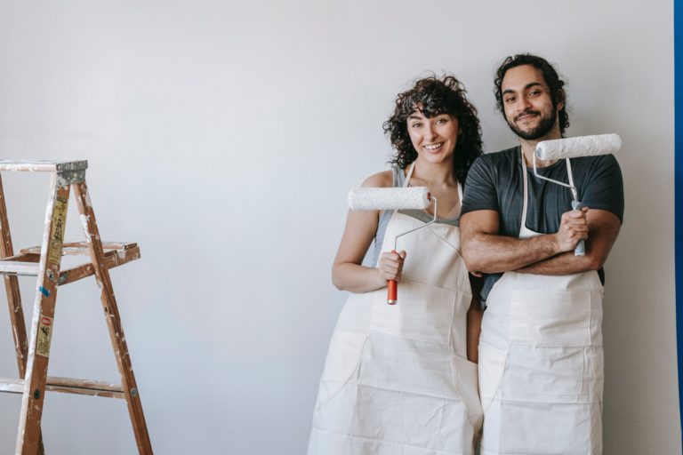 a man and woman standing next to each other and smiling