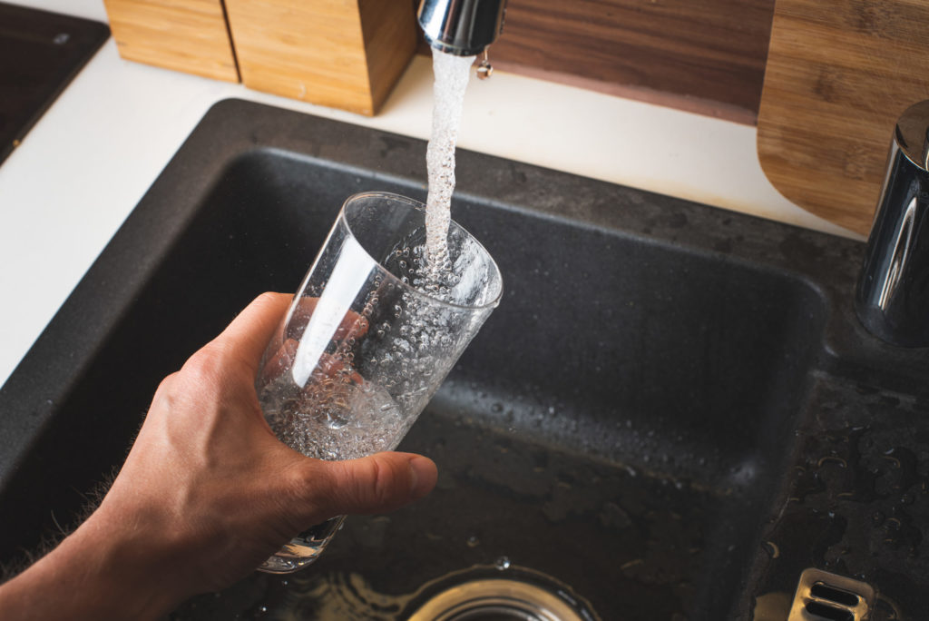 a person pouring a liquid into a pan