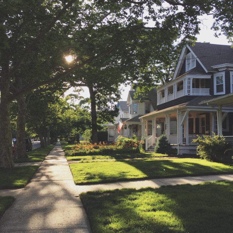 a house with a driveway and trees