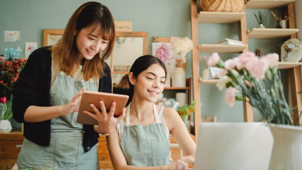 a person holding a tablet next to a person