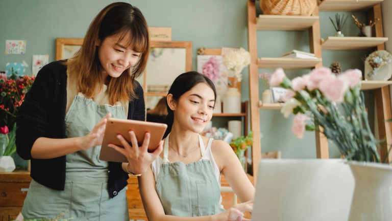 a person holding a tablet next to a person