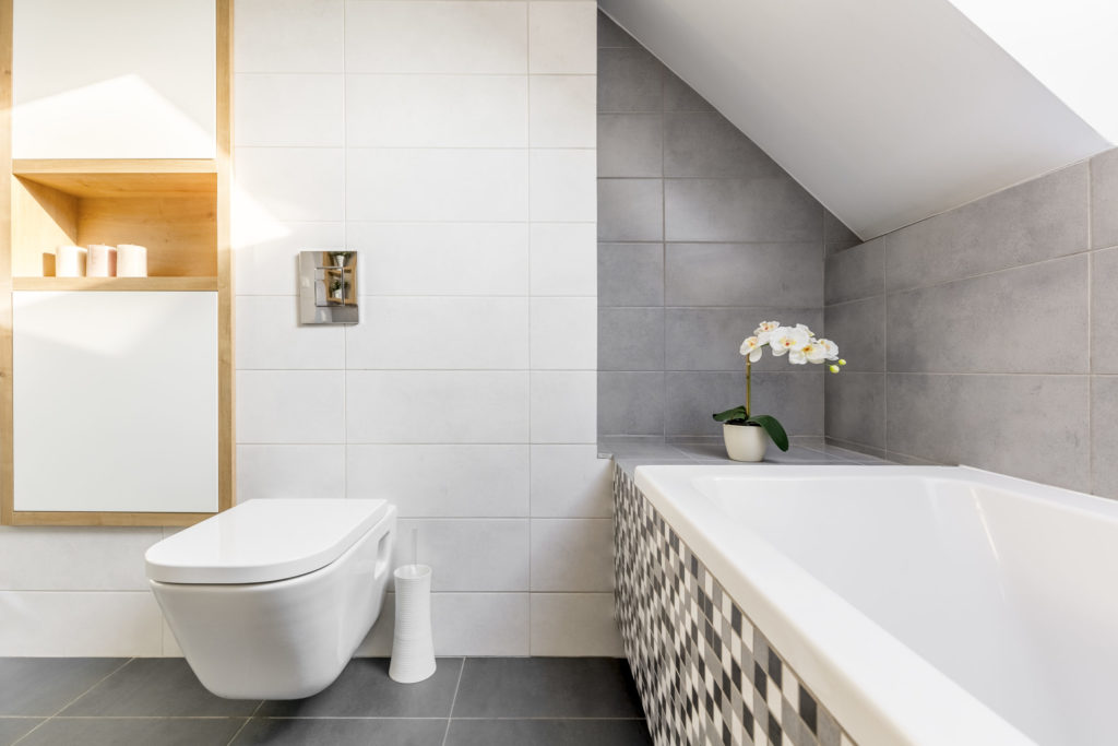 a bathroom with a tub and toilet