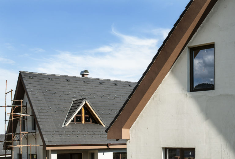 a house with a ladder and a chimney on the roof