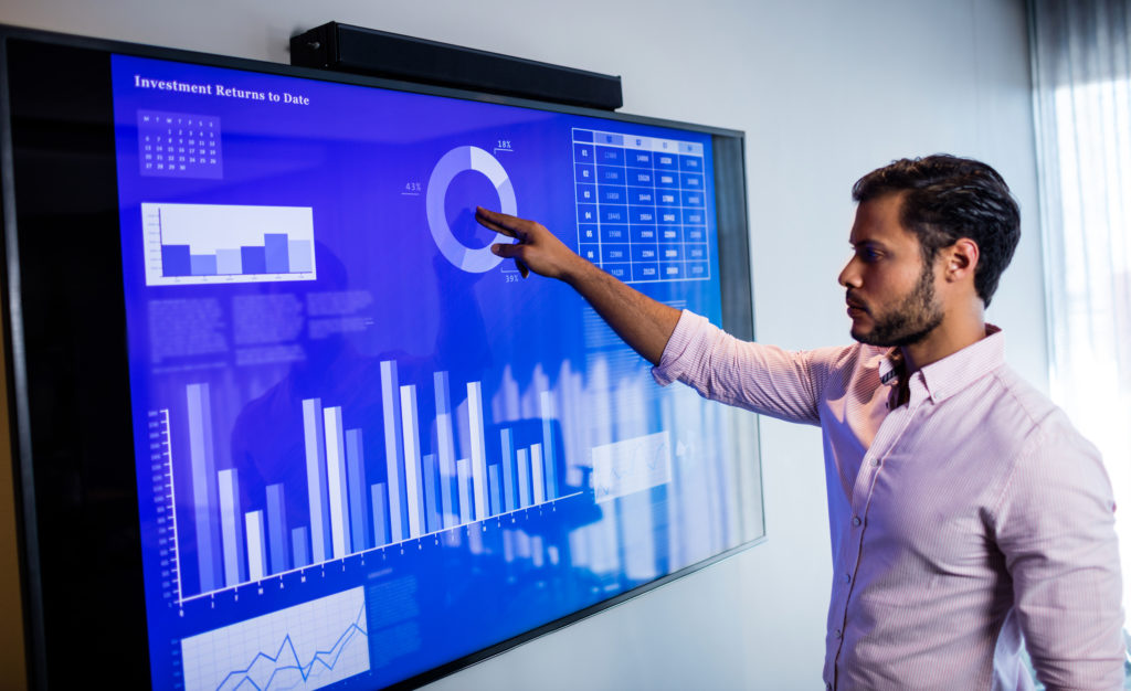 a man pointing at a screen