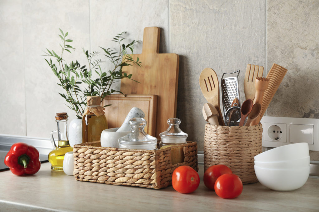 a table with a basket of food and a basket with a plant in it