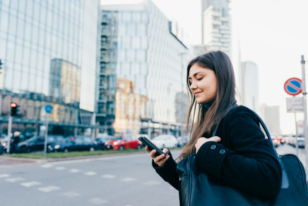 Young woman using smartphone outdoor